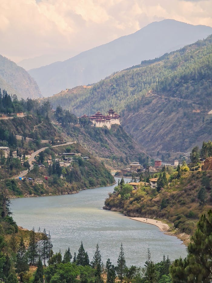A stunning view of Wangdue Phodrang Monastery amidst the serene Bhutanese valley and river.