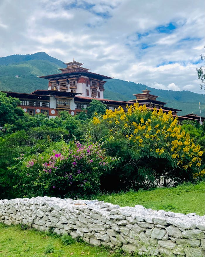 Beautiful view of Punakha Dzong surrounded by lush greenery and vibrant flowers in Bhutan.