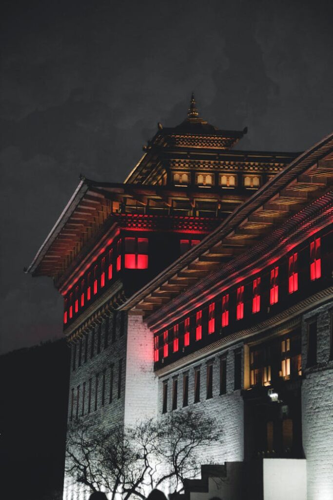 A captivating night shot of Thimphu architecture with illuminated windows, highlighting Bhutanese heritage.